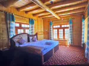 a bedroom with a bed in a wooden room at Guru view Home stay in Padam