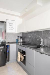 a kitchen with a sink and a counter at Modern 31sqm studio in Helsinki in Helsinki