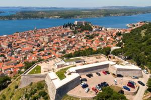 an aerial view of a city with a large building at Holiday Home Tesla in Šibenik