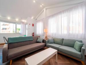 a living room with a couch and a table at La Isla , tu hogar en Torre del Mar. in Torre del Mar