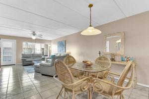 a living room with a table and chairs at Beachfront convenience w/o the beachfront price! in South Padre Island