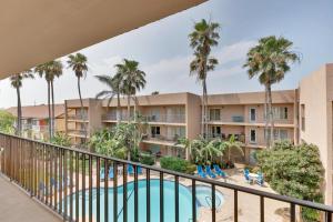a view of a resort with a swimming pool and palm trees at Beachfront convenience w/o the beachfront price! in South Padre Island