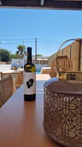 a bottle of wine sitting on top of a table at RASTONI VILLAS BY AEGEAN HOUSES in Psalidi