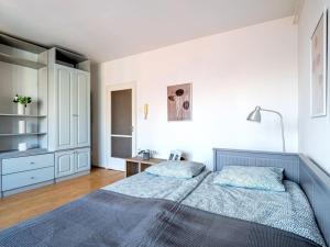 a bedroom with two beds and a white wall at Shiny Buda Studio in Budapest