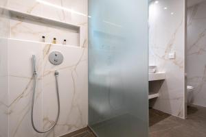 a shower with a glass door in a bathroom at GRAND PATELLI in Myrina