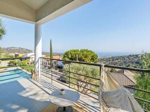 a balcony with a hammock and a view of the ocean at Villa Alella Panoramic Views in Alella