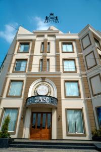 a building with a clock on the front of it at Hotel A9 Barnala in Barnāla