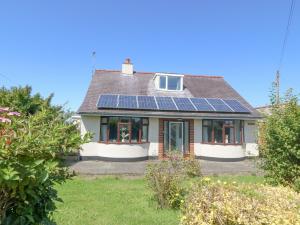 a house with solar panels on the roof at Awelfryn in Holyhead