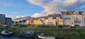a group of boats parked in front of a house at Port Haverigg Millom in Millom