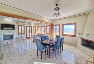 a living room with a table and chairs and a couch at Majestic View Resort in Nafpaktos