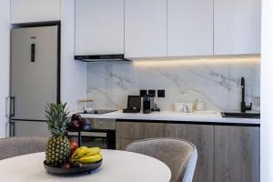 a kitchen with a table with a pineapple on it at The Kokoon Volos Comfort Living in Volos