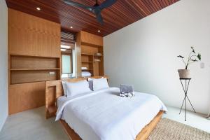 a bedroom with a large bed with a wooden ceiling at Amazing 3BDR-Villa Canggu/Seseh 2min walk to Beach in Canggu +50 photos