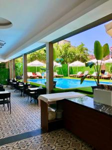 a resort with a pool and tables and chairs at Wolf Of The City Hotel & Spa in Antalya