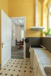 a kitchen with a sink and a stove top oven at Casanova94 Guesthouse in Piraeus