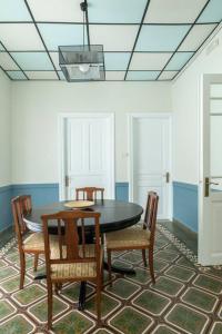 a dining room with a black table and chairs at Casanova94 Guesthouse in Piraeus