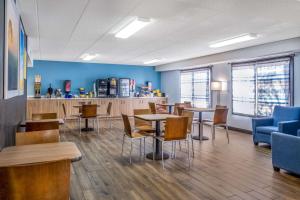 a waiting room with tables and chairs and a counter at Days Inn by Wyndham Sioux Falls Airport in Sioux Falls