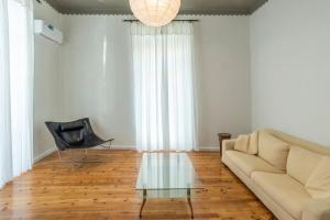 a living room with a couch and a glass table at Casanova94 Guesthouse in Piraeus