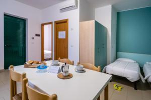a room with a table and chairs and a bed at Stork Family Camping Village in Giulianova