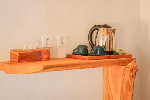 a wooden shelf with a tea kettle on it at Hillside bali in Kubupenlokan