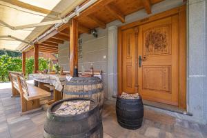 patio con mesa, sillas y puerta de madera en Vineyard Cottage Stepan - Happy Rentals, en Črnomelj