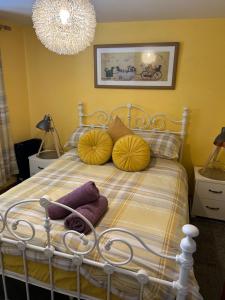 a bedroom with a bed with yellow walls and a chandelier at Saint Blue Apartment in Tain