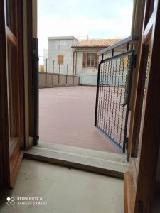 an open door to a courtyard with a gate at Nuovi bilocali Panta Rei - Suite della Terra in Senigallia