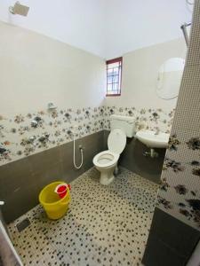 a bathroom with a toilet and a sink at Rosh Tower in Trivandrum