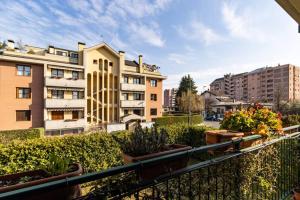 a balcony with plants and buildings in a city at [Monza] Monolocale completo in Monza