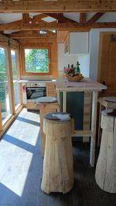 a kitchen with stools and a counter in a cabin at Ferienhaus am Bückeberg in Gernrode - Harz