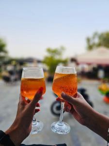 two people holding up two glasses of beer at Urszula's apartment - apartments by the sea in Áyios Andréas Messinias