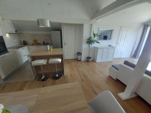 a kitchen and living room with a table and a couch at One bedroom loft apartment with nice view in Nin
