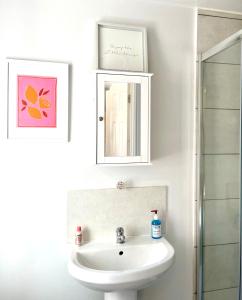 a white bathroom with a sink and a mirror at Northumberland Boutique Guest House #5 in Coventry