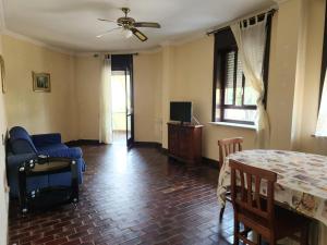 sala de estar con mesa y silla azul en Casa di Adele, en Anzio
