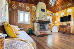 a living room with a fireplace and wooden walls at Chalé da Caniçada By Sé Apartamentos in Rio Caldo