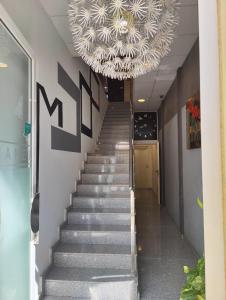 a staircase with a chandelier in a building at Hostal Manel in Pineda de Mar