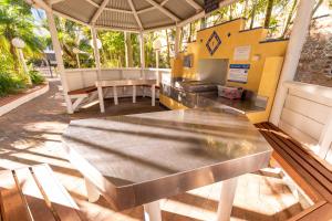 a stainless steel table on a patio with a grill at Aegean Resort Apartments in Gold Coast