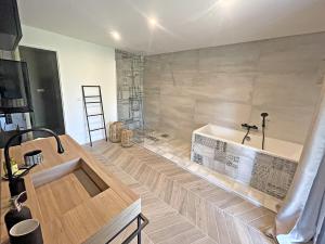 a bathroom with a bath tub in a room at Mas Benoit in Salernes