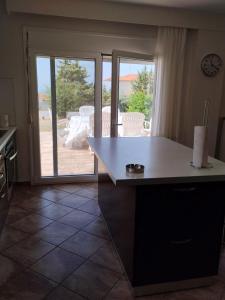 a kitchen with a table and a view of a patio at Summer and Winter Villas in Néa Tríglia