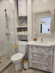 a bathroom with a toilet and a sink and a mirror at Beach Apartment - Benalmadena Costa in Benalmádena
