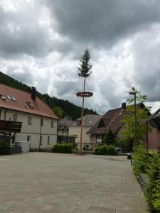 a large parking lot in a town with a tree at Gasthaus Waldhorn in Bad Teinach-Zavelstein