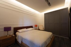 a bedroom with a bed and a night stand with a lamp at Palazzo Monterone in Forio d'Ischia