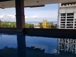 a swimming pool with a view of a building at Hospital ng Manila front delux le mirage de malate in Manila +14 photos