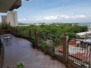 a balcony with a railing and a patio with plants at Hospital ng Manila front delux le mirage de malate in Manila