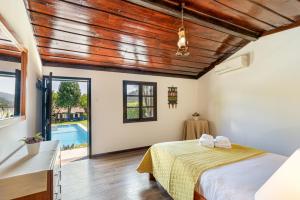 a bedroom with a bed and a pool at Chalé da Caniçada By Sé Apartamentos in Rio Caldo +37 photos