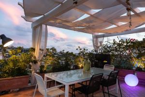 a patio with a table and chairs on a balcony at Palazzo Monterone in Forio d'Ischia