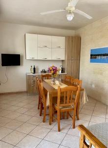 a kitchen and dining room with a table and chairs at Villetta Giada in San Pietro in Bevagna +29 photos