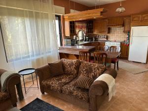 a living room with a couch and a kitchen at The Rainbow Residence 2 in Amman