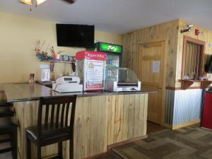 a bar in a restaurant with a cash register at Gold Country Inn in Deadwood