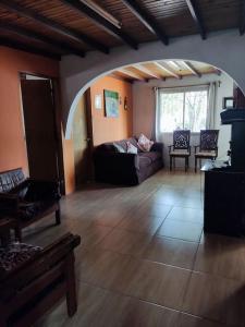 a living room with a couch and a large window at Casa, para máximo 6 personas in Melo