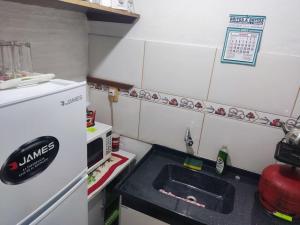 a small kitchen with a sink and a refrigerator at Casa, para máximo 6 personas in Melo